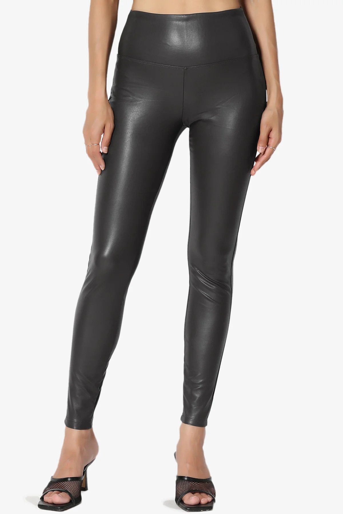 A woman wearing black leather leggings