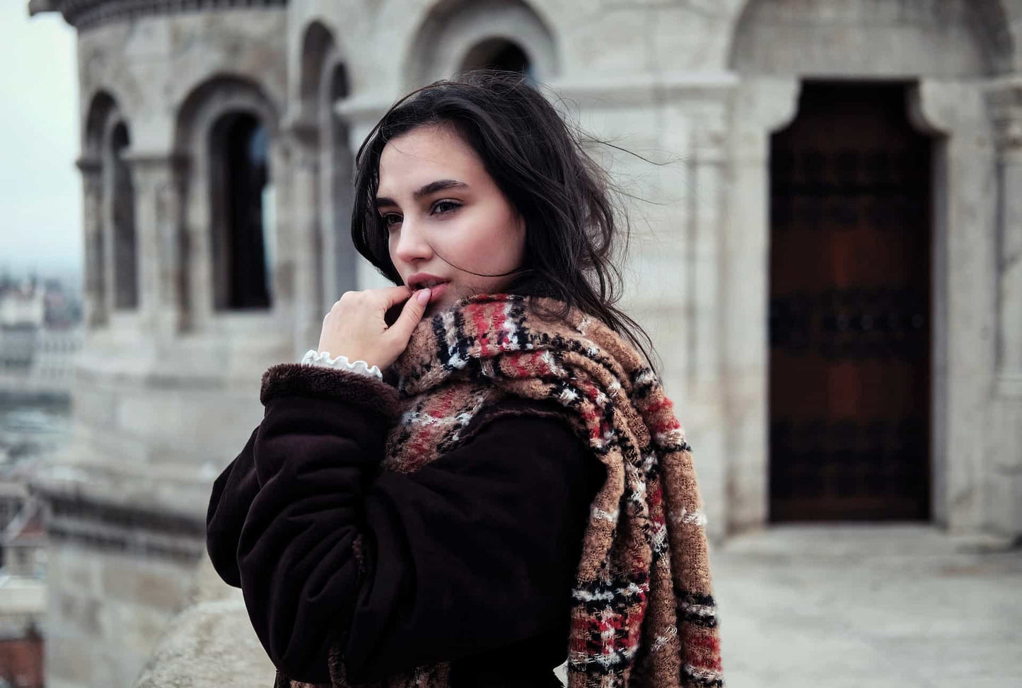 A woman wearing a coat and a scarf